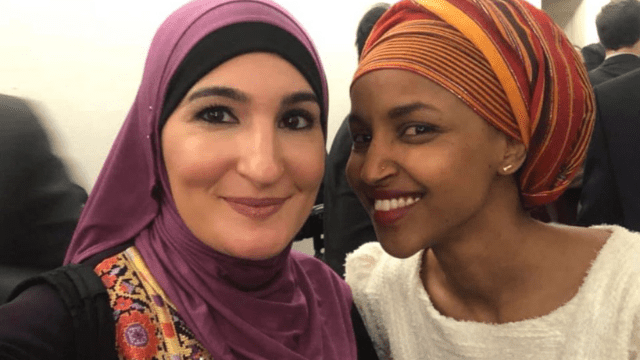 Ilhan Omar and Woman in Hajib Smiling